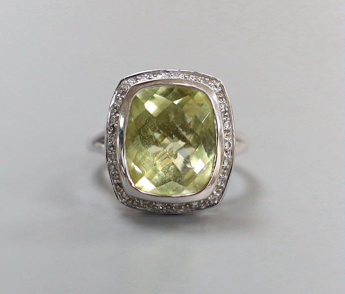 A modern 18k white metal, fancy cut quartz and diamond chip cluster set dress ring, size N, gross weight 7.4 grams.